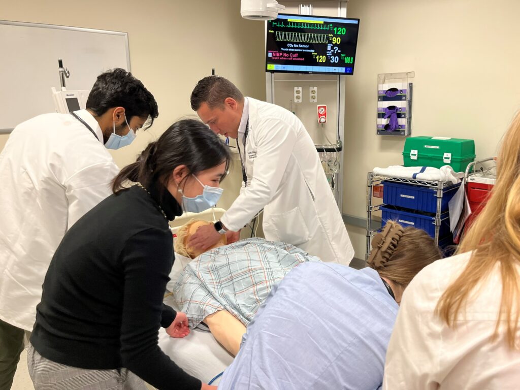 Harvard Medical School students practice diagnosing a pneumothorax in a trauma patient in a clinical scenario, in the HMS Pre-Clinical EM ICM Course.